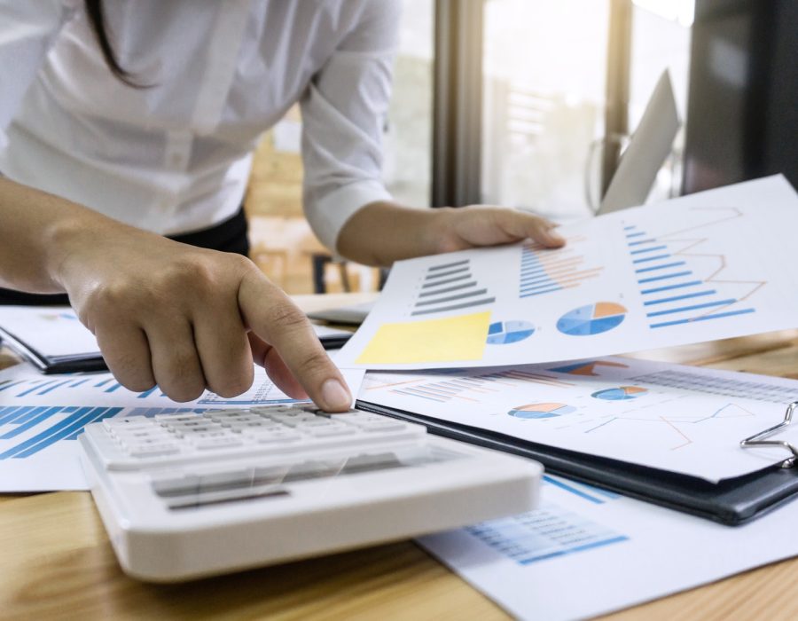 business-woman-accountant-working-and-calculating-financial-data-on-graph-documents.jpg